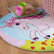 Illustration - Ihr Experte für schönes Wohnen - Ein runder Kinderteppich mit einem Einhornmotiv.